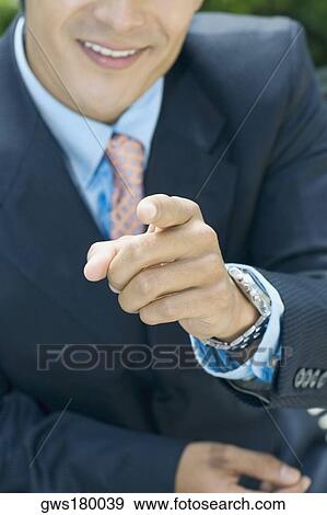 Stock Photo - Close-up of a businessman pointing forward. Fotosearch