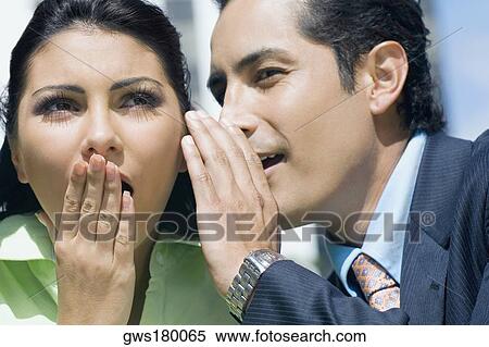 Close-up of a businessman whispering into a businesswoman's ear View Large Photo Image Stock Photography - Close-up of a businessman whispering into a businesswoman's ear. Fotosearch