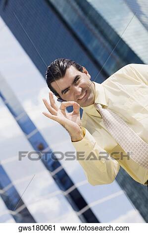 Portrait of a businessman making an OK sign View Large Photo Image Stock Image - Portrait of a businessman making an OK sign. Fotosearch
