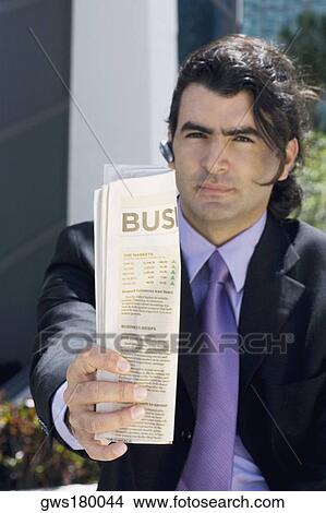Portrait of a businessman showing a newspaper View Large Photo Image Picture - Portrait of a businessman showing a newspaper. Fotosearch
