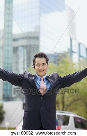 Portrait of a businessman standing with his arms outstretched and smiling View Large Photo Image Stock Image - Portrait of a businessman standing with his arms outstretched and smiling. Fotosearch