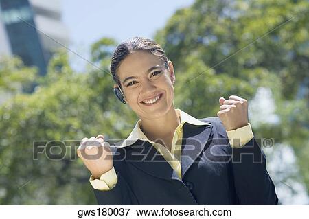 Stock Photo - Portrait of a businesswoman clenching her fist. Fotosearch