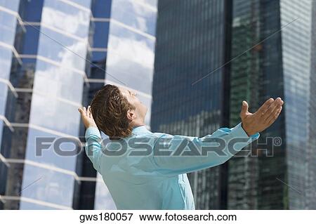 Stock Photo - Rear view of a businessman with his arms outstretched. Fotosearch