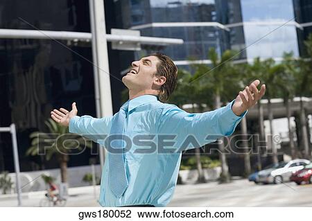 Side profile of a businessman standing with his arms outstretched View Large Photo Image Stock Image - Side profile of a businessman standing with his arms outstretched. Fotosearch