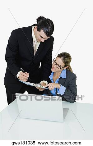 Businessman and a businesswoman working in an office View Large Photo Image Stock Photography - Businessman and a businesswoman working in an office. Fotosearch
