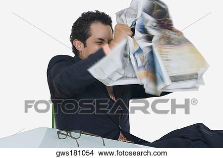 Businessman tearing a newspaper in frustration View Large Photo Image Picture - Businessman tearing a newspaper in frustration. Fotosearch