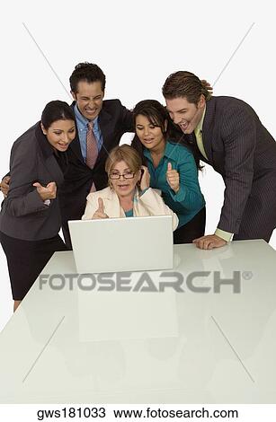 Businesswoman using a laptop with four business executives beside her View Large Photo Image Stock Image - Businesswoman using a laptop with four business executives beside her. Fotosearch