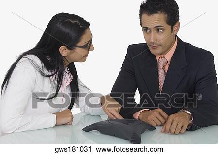 Close-up of a businessman and a businesswoman discussing in a boardroom View Large Photo Image Stock Image - Close-up of a businessman and a businesswoman discussing in a boardroom. Fotosearch