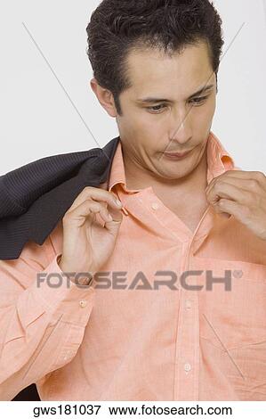 Close-up of a businessman blowing in a shirt View Large Photo Image Stock Photo - Close-up of a businessman blowing in a shirt. Fotosearch