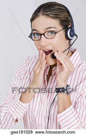 Portrait of a businesswoman wearing a headset and looking surprised View Large Photo Image Stock Photo - Portrait of a businesswoman wearing a headset and looking surprised. Fotosearch
