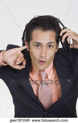 Stock Photo - Portrait of a young man wearing headphones. Fotosearch