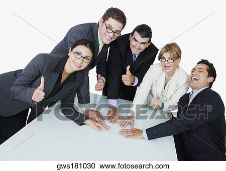 Portrait of two businesswomen and three businessmen placing their hands on the table View Large Photo Image Stock Image - Portrait of two businesswomen and three businessmen placing their hands on the table. Fotosearch