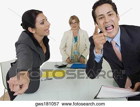 Side profile of a businesswoman pointing at another businessman standing in front of her View Large Photo Image Stock Photo - Side profile of a businesswoman pointing at another businessman standing in front of her. Fotosearch