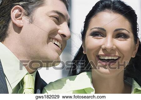 Close-up of a businessman and a businesswoman smiling View Large Photo Image Stock Photo - Close-up of a businessman and a businesswoman smiling. Fotosearch