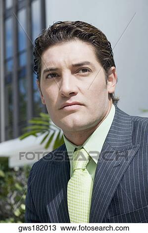 Close-up of a businessman looking serious View Large Photo Image Stock Image - Close-up of a businessman looking serious. Fotosearch