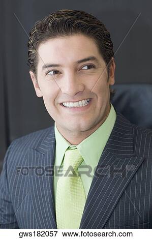 Close-up of a businessman smiling View Large Photo Image Stock Photo - Close-up of a businessman smiling. Fotosearch
