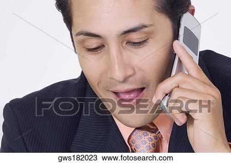 Close-up of a businessman talking on a mobile phone View Large Photo Image Stock Image - Close-up of a businessman talking on a mobile phone. Fotosearch