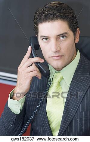 Close-up of a businessman talking on the telephone View Large Photo Image Stock Photo - Close-up of a businessman talking on the telephone. Fotosearch