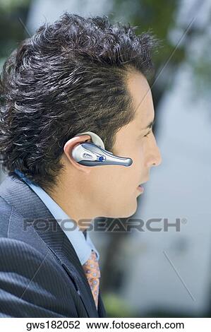 Close-up of a businessman wearing a hands free device View Large Photo Image Stock Image - Close-up of a businessman wearing a hands free device. Fotosearch