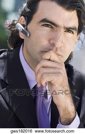 Close-up of a businessman wearing a hands free device View Large Photo Image Stock Photograph - Close-up of a businessman wearing a hands free device. Fotosearch
