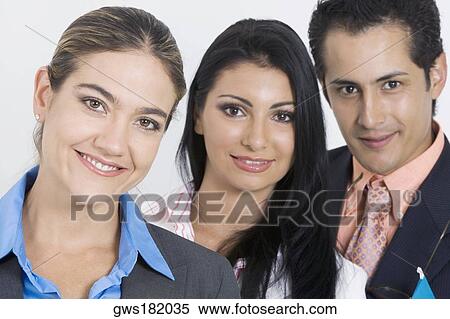 Portrait of a businessman and two businesswomen smiling View Large Photo Image Stock Photography - Portrait of a businessman and two businesswomen smiling. Fotosearch