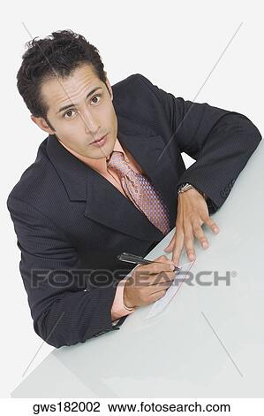 Portrait of a businessman signing a check View Large Photo Image Stock Image - Portrait of a businessman signing a check. Fotosearch