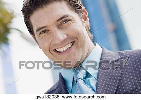 Portrait of a businessman smiling View Large Photo Image Stock Photograph - Portrait of a businessman smiling. Fotosearch