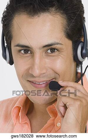 Portrait of a businessman wearing a headset and smiling View Large Photo Image Stock Photo - Portrait of a businessman wearing a headset and smiling. Fotosearch