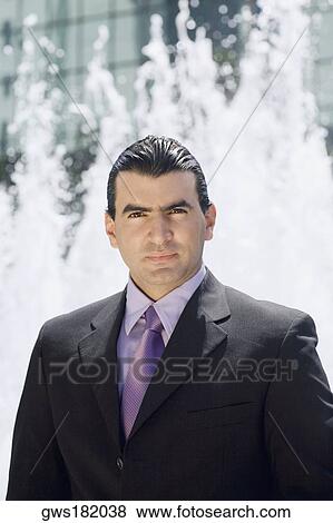 Portrait of a businessman with a fountain in the background View Large Photo Image Stock Photo - Portrait of a businessman with a fountain in the background. Fotosearch