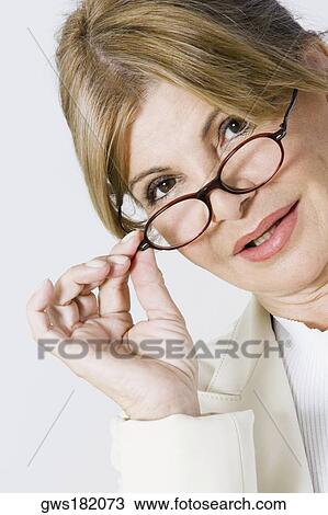 Portrait of a businesswoman adjusting her eyeglasses View Large Photo Image Stock Image - Portrait of a businesswoman adjusting her eyeglasses. Fotosearch