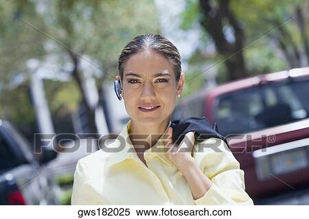 Portrait of a businesswoman carrying a coat on her shoulder and smiling View Large Photo Image Stock Photography - Portrait of a businesswoman carrying a coat on her shoulder and smiling. Fotosearch