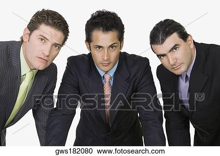 Stock Image - Portrait of three businessmen standing together. Fotosearch