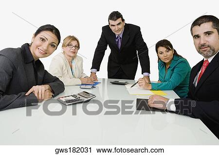 Stock Image - Portrait of two businessmen with three businesswomen in an office. Fotosearch