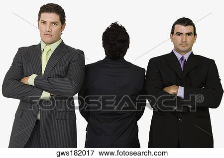 Rear view of a businessman standing with two businessmen with their arms crossed View Large Photo Image Stock Photo - Rear view of a businessman standing with two businessmen with their arms crossed. Fotosearch