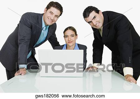 Two businessmen and a businesswoman in a conference room View Large Photo Image Stock Photograph - Two businessmen and a businesswoman in a conference room. Fotosearch