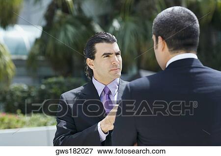 Two businessmen discussing View Large Photo Image Stock Photo - Two businessmen discussing. Fotosearch
