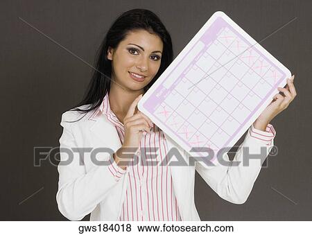 Close-up of a businesswoman holding a calendar View Large Photo Image Stock Photo - Close-up of a businesswoman holding a calendar. Fotosearch