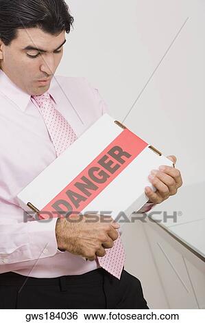 High angle view of a businessman carrying a package View Large Photo Image Stock Photograph - High angle view of a businessman carrying a package. Fotosearch