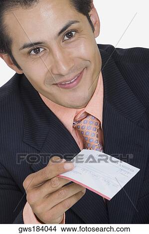 Portrait of a businessman holding a check and smiling View Large Photo Image Picture - Portrait of a businessman holding a check and smiling. Fotosearch