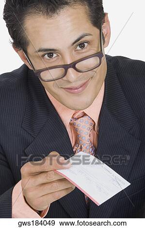 Portrait of a businessman holding a check View Large Photo Image Stock Photo - Portrait of a businessman holding a check. Fotosearch