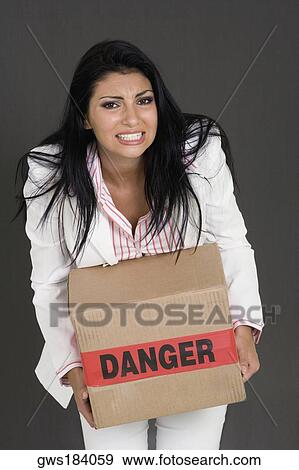 Portrait of a businesswoman carrying a cardboard box View Large Photo Image Stock Photo - Portrait of a businesswoman carrying a cardboard box. Fotosearch