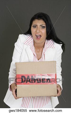 Portrait of a businesswoman carrying a cardboard box View Large Photo Image Stock Photography - Portrait of a businesswoman carrying a cardboard box. Fotosearch