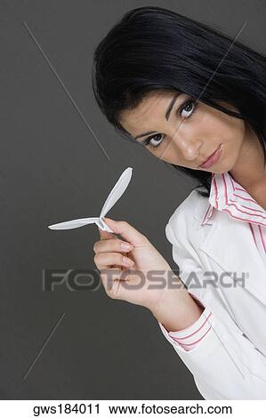 Portrait of a businesswoman holding a paper airplane View Large Photo Image Stock Image - Portrait of a businesswoman holding a paper airplane. Fotosearch