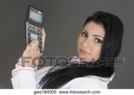 Portrait of a businesswoman holding a calculator View Large Photo Image Stock Photography - Portrait of a businesswoman holding a calculator. Fotosearch