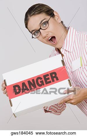 Portrait of a businesswoman holding a package View Large Photo Image Stock Photography - Portrait of a businesswoman holding a package. Fotosearch