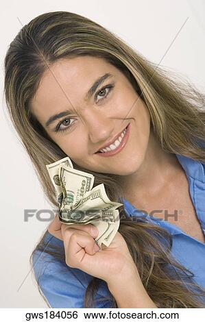 Portrait of a young woman holding American paper currency View Large Photo Image Stock Photograph - Portrait of a young woman holding American paper currency. Fotosearch