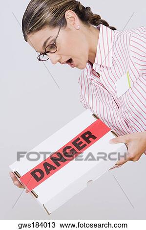 Side profile of a businesswoman holding a package View Large Photo Image Stock Image - Side profile of a businesswoman holding a package. Fotosearch