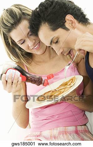 Close-up of a young couple having breakfast View Large Photo Image Stock Image - Close-up of a young couple having breakfast. Fotosearch