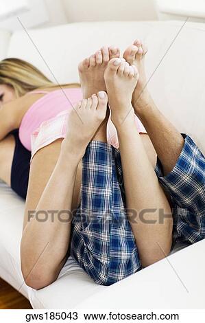 Rear view of a young woman lying on a young man's back View Large Photo Image Stock Image - Rear view of a young woman lying on a young man's back. Fotosearch