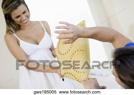 Young couple pillow fighting View Large Photo Image Stock Photography - Young couple pillow fighting. Fotosearch